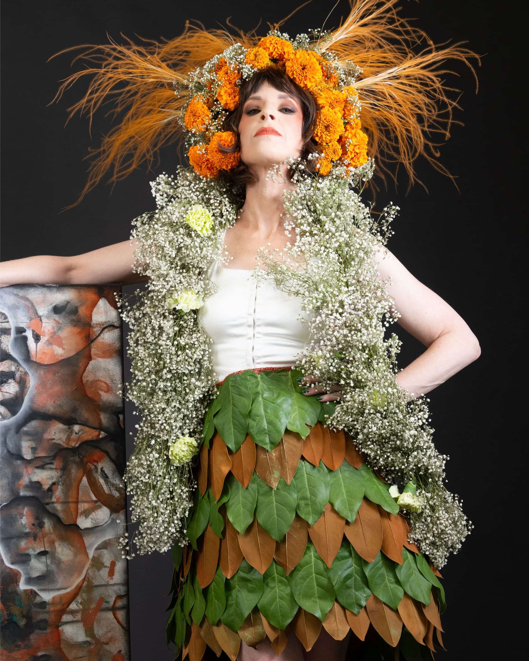 Styled photo shoot with a floral headpiece and alternating leaf skirt